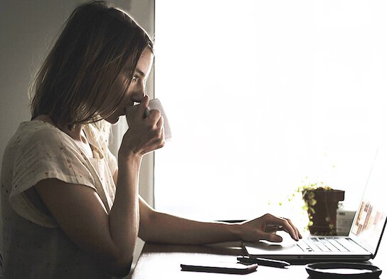 Woman doing online course on laptop at home.